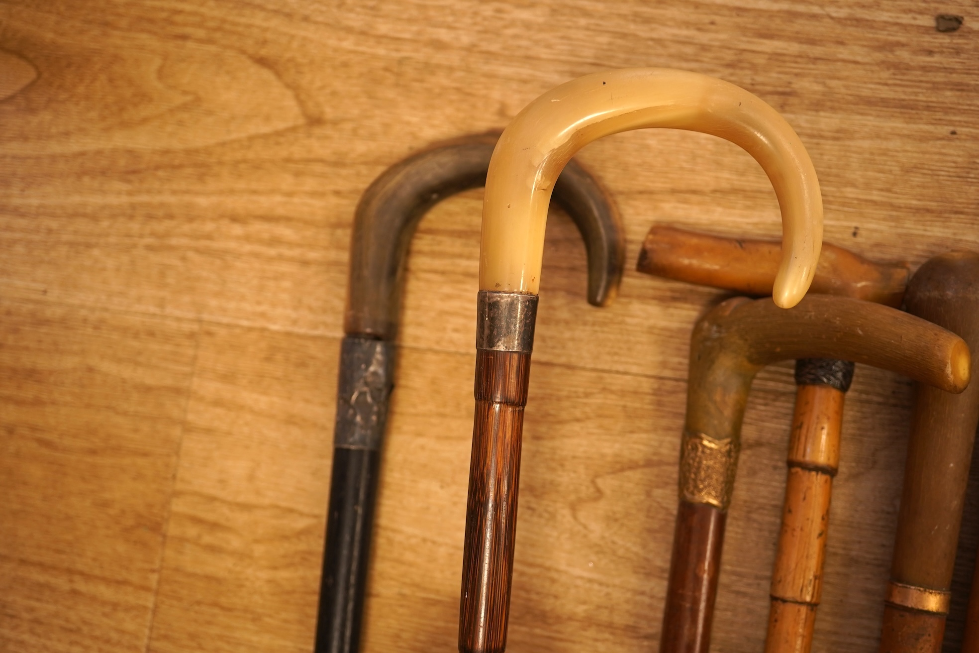 A collection of seven horn handles walking sticks some gold and white metal mounted